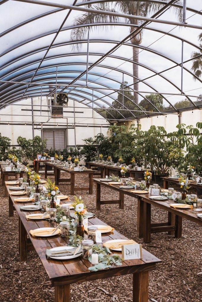 Eco-Friendly Wedding Venue with long tables set up with place settings