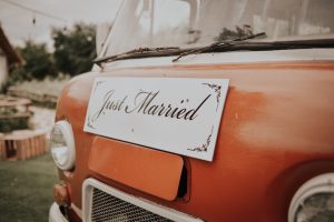 Just Married sign on the front of an orange van