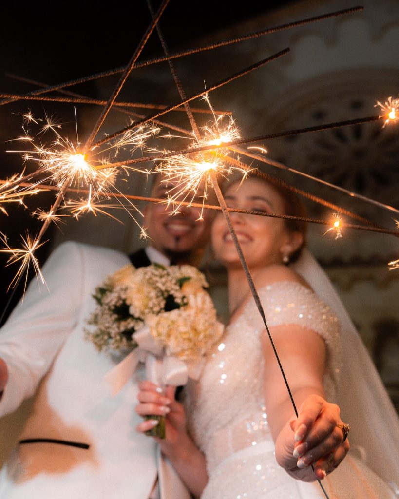 Bride and groom holding wedding sparklers