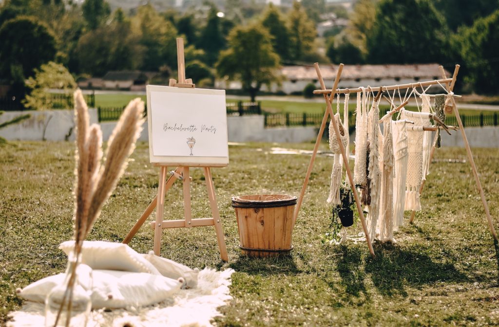 Bachelorette wedding shower props in a grassy field
