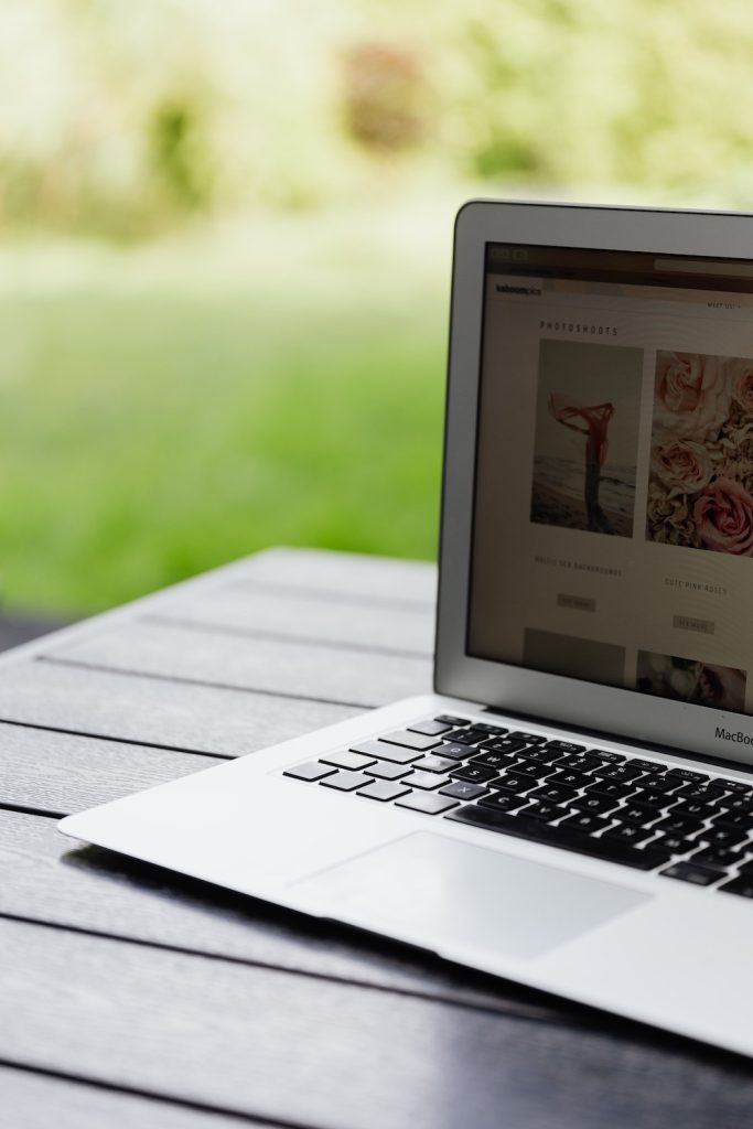 Laptop sitting on a table with a wedding website on the screen