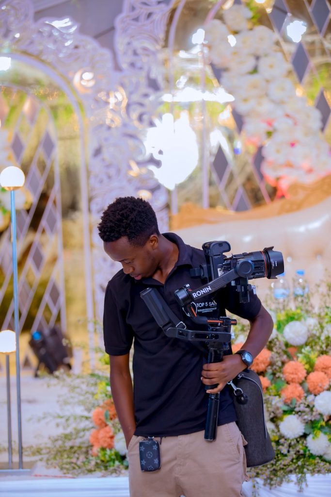 Male standing with his camera for wedding video