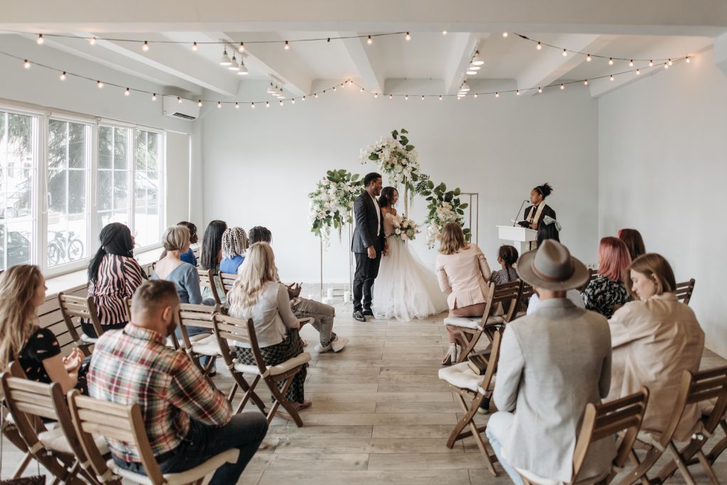 Wedding ceremony rehearsal with guests looking on