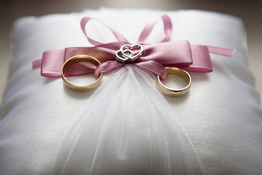 Wedding dress with wedding rings sitting on top