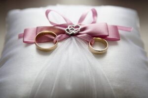 Wedding dress with wedding rings sitting on top