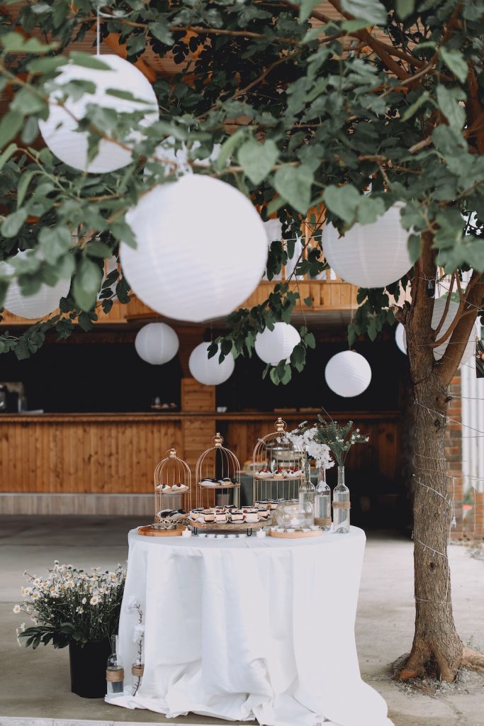 Wedding lanterns strung between the trees over a wedding table