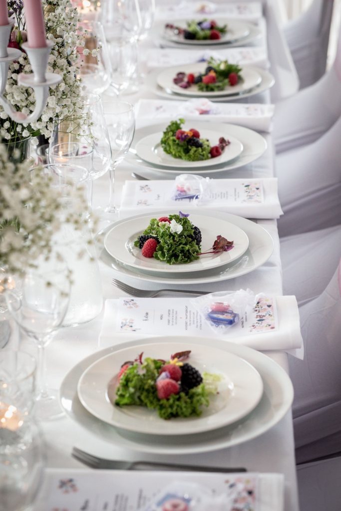 Plates of vegan food laid out on the table at a wedding