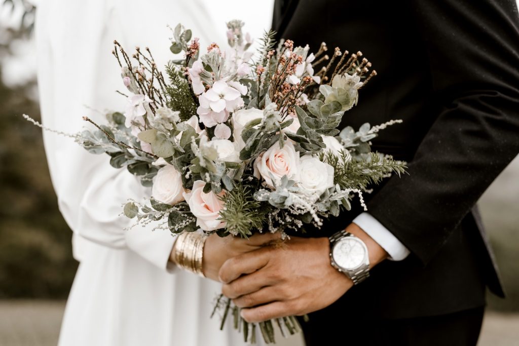 Bride and groom holding a wedding bouquet