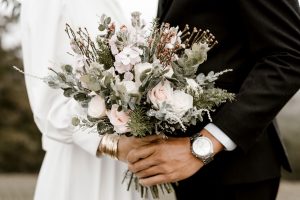 Bride and groom holding a wedding bouquet