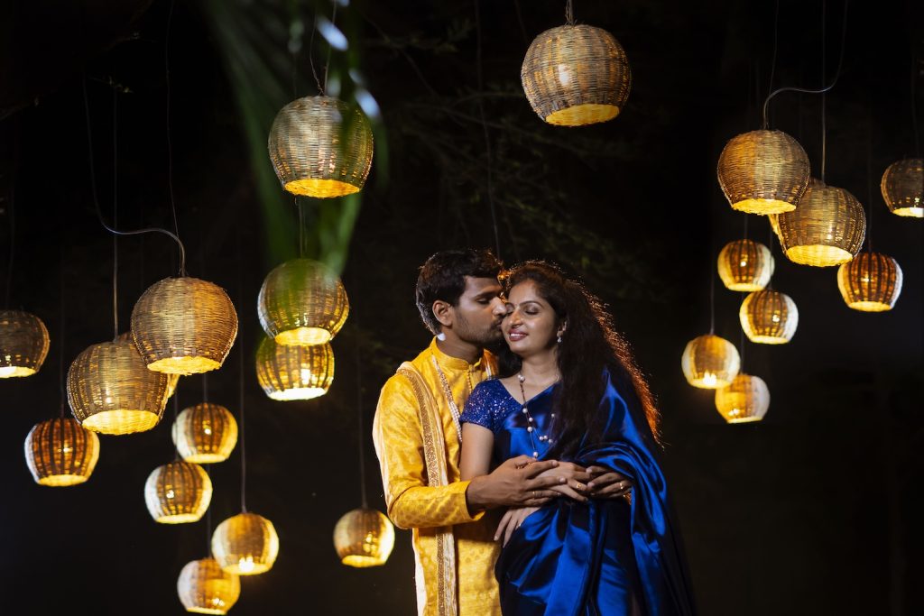 Couple standing under sustainable wedding lighting