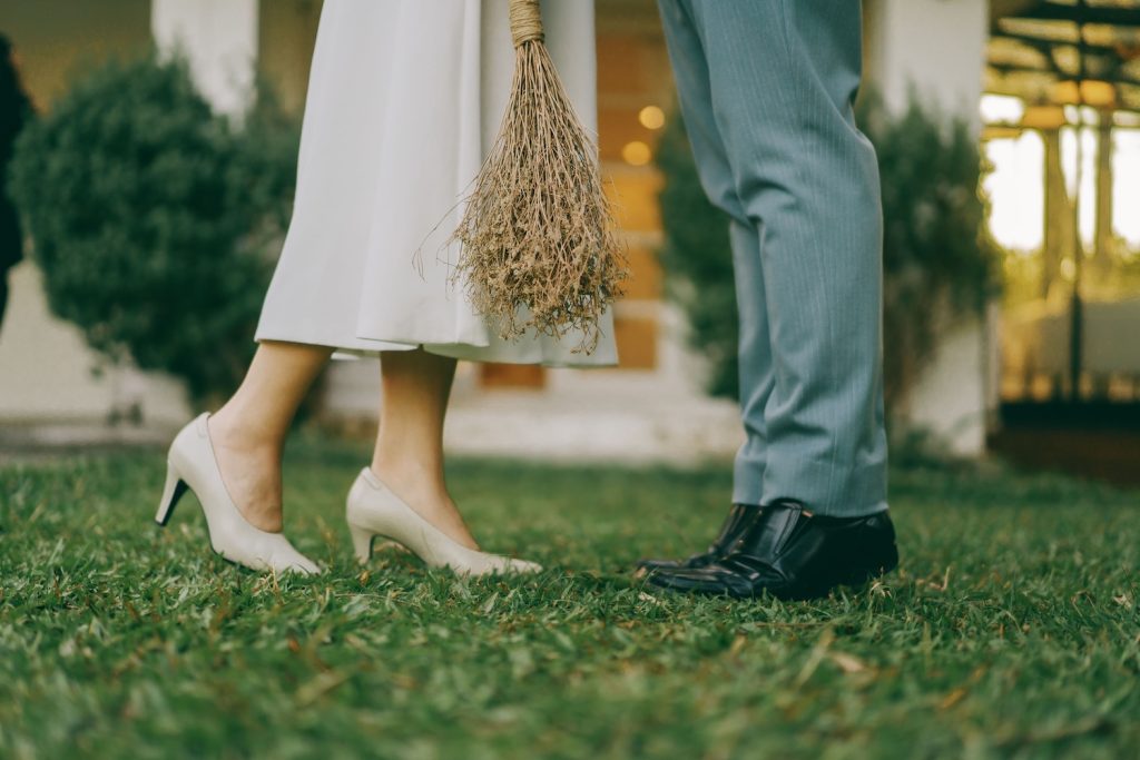 Bride and groom standing on the grass at their wedding